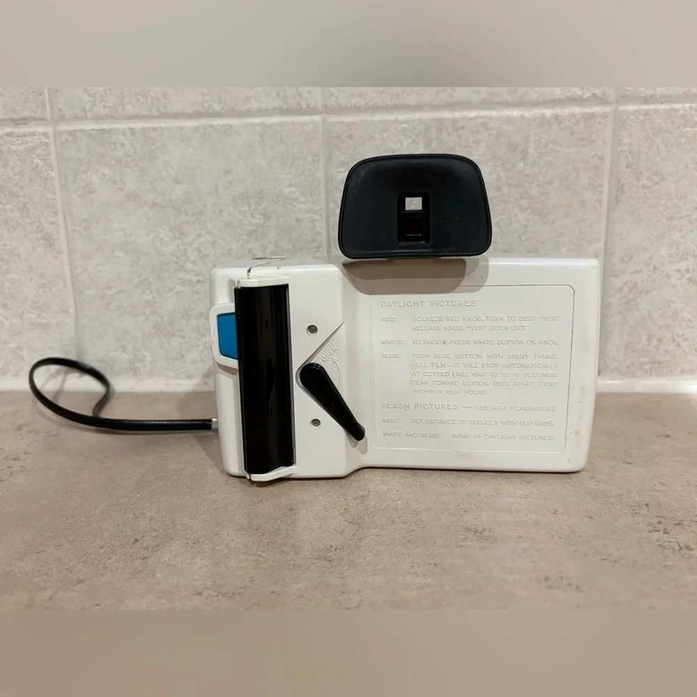 Vintage Polaroid Swinger camera and case